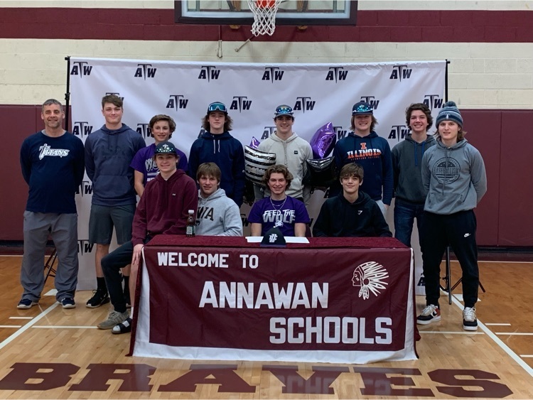 Mason Heitzler surrounded by Titans baseball teammates as he signs to play baseball for Joliet Junior College.