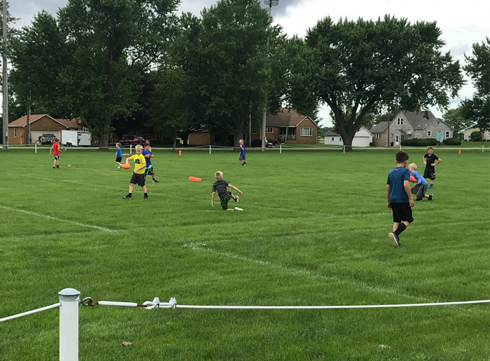 Boys playing football on football field